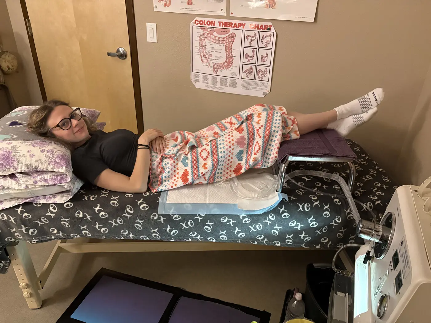A client resting comfortably on the table in the treatment room